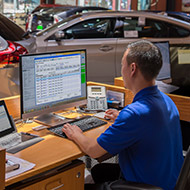 Man working on a computer at a dealership