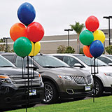 Balloons decorating a car lot.