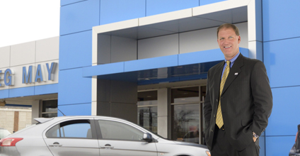 Greg May standing outside dealership