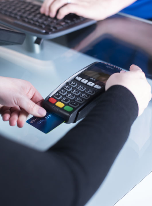 customer paying with credit card at payment terminal