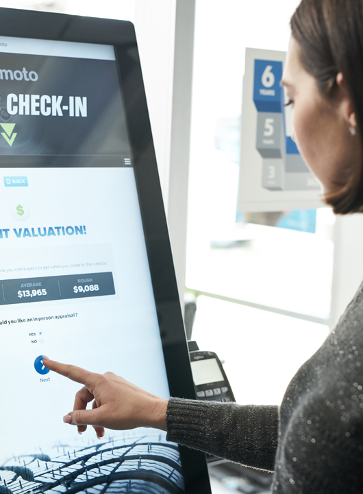 Woman using kiosk